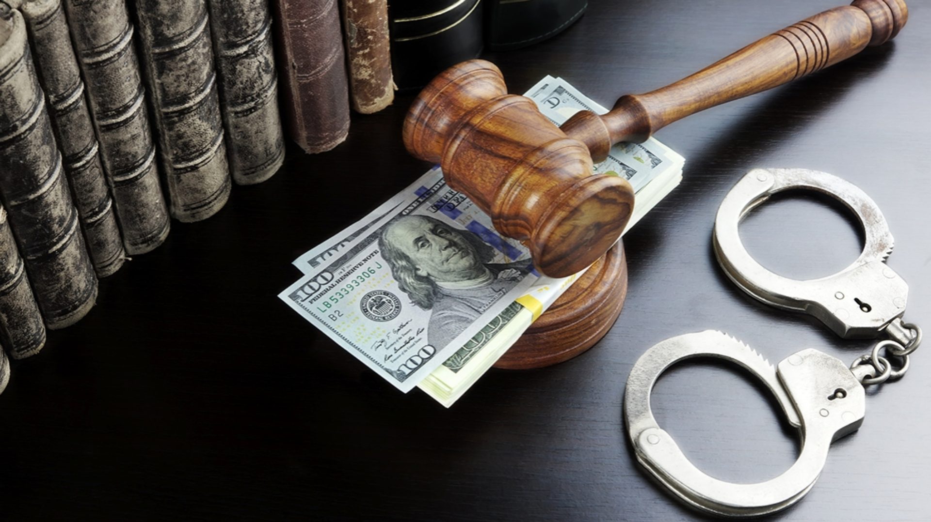 Image of Handcuffs, Gavel and Dollar Bill